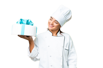 Woman pastry chef with a big cake with happy expression