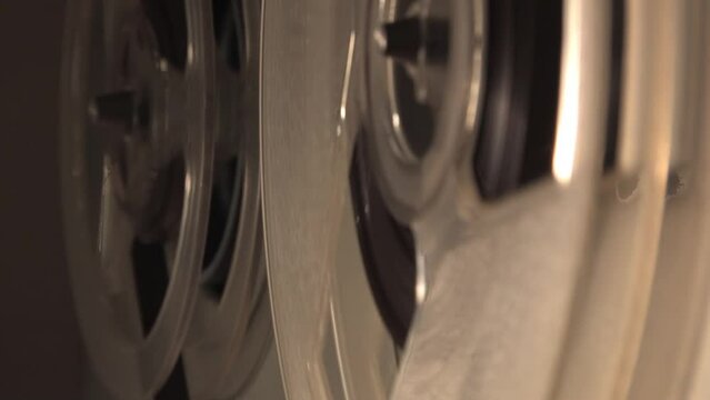 On the reel-to-reel tape recorder, the reels rotate, the tape turns. Sound recording device, high-quality sound, spy tape recorder.