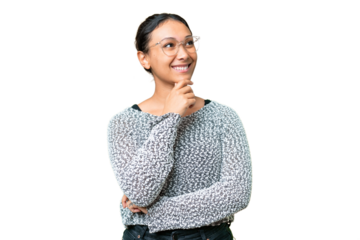 Young Uruguayan woman over isolated chroma key background looking up while smiling