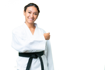 Young Uruguayan woman doing karate over isolated chroma key background pointing back