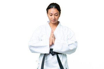 Young Uruguayan woman over isolated chroma key background doing karate and saluting