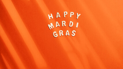 Happy Mardi Gras sign on orange Background