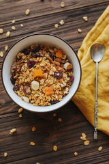 Healthy breakfast oatmeal with fruits in plate on wooden background