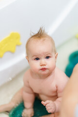 Cute Caucasian Baby takes a bath