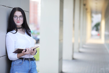 Girl student on the street with books