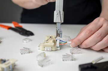 Mounting the RJ45 module, attaching the wire to the computer socket in the room.