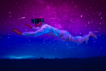 Obraz na płótnie Canvas mind of man expand him to fly limitless through space, with VR glasses project a breathtaking view of cosmos when he float weightlessly among stars and marvel at wonders of universe