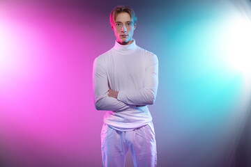 young man in white clothes stand with crossed arms look futuristic and innovative as he would be...
