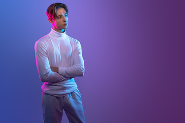 young man in white clothes stand with crossed arms look futuristic and innovative as he would be...