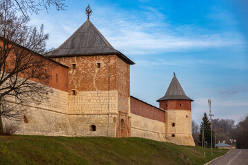 Fototapeta na wymiar Medieval wall of the Zaraysk Kremlin with St. George Gate Tower and Hiding-place Corner Tower, Moscow region, Russia. Cultural heritage of the Middle Ages (16th century) in the Moscow region, Russia