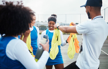 Coach, vest or team in netball training game, workout or exercise for a match on sports court. Teamwork, fitness group or manager giving bibs to excited athlete girls with happy smile in practice