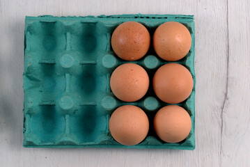 Green carton of fresh eggs