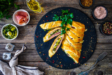 Pork ham with cooked leek and cheese wrapped in puff pastry
