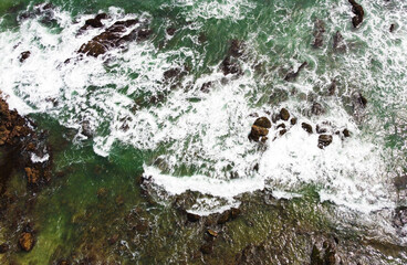 Aerial view of the sea rocks cliffs in the ocean. Beautiful sea wallpaper for tourism and advertising. Stormy landscape, drone photo