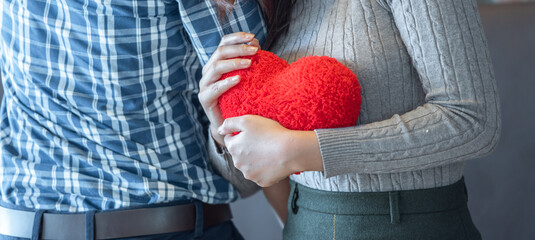 banner of Lover couple happy in love relaxing on sofa looking in eye smiling teasing with big red...