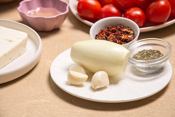 Fototapeta na wymiar Peeled onion and garlic among vegetables