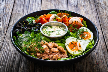 Nicoise salad - tuna, hard boiled eggs, greens, tomatoes and black olives
