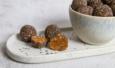 Healthy homemade delicious organic energy balls made from figs, nuts and chiha seeds on white...