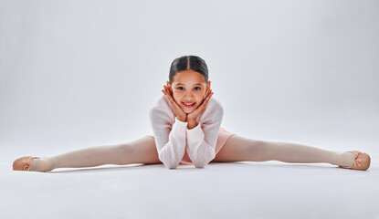 Ballet, dancer and young girl doing the split, smile in portrait with fitness, dancing and sport isolated on white studio background. Ballerina, training and dance in studio, athlete and stretching