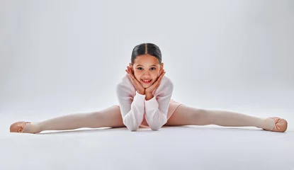 Abwaschbare Fototapete Tanzschule Ballet, dancer and young girl doing the split, smile in portrait with fitness, dancing and sport isolated on white studio background. Ballerina, training and dance in studio, athlete and stretching