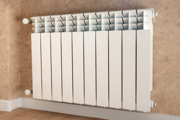 Multisection heating radiator with taps on the wall