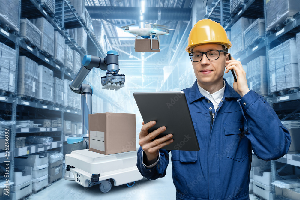 Aufkleber Manager with digital tablet and phone in an automated warehouse with robots and drones