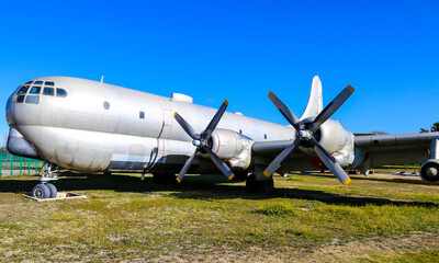 Old propeller plane on the green field.
