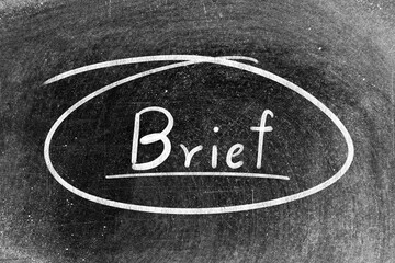 White chalk hand writing in word brief and circle shape on blackboard background