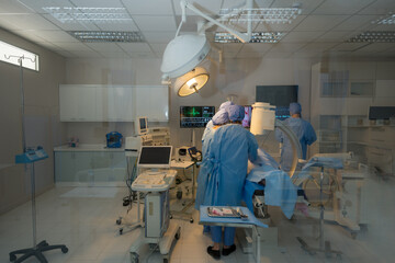 Doctor, nurse doing surgery on patient.