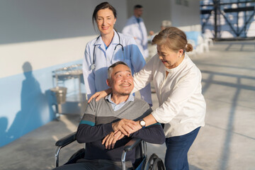 Doctor pushing a wheelchair.