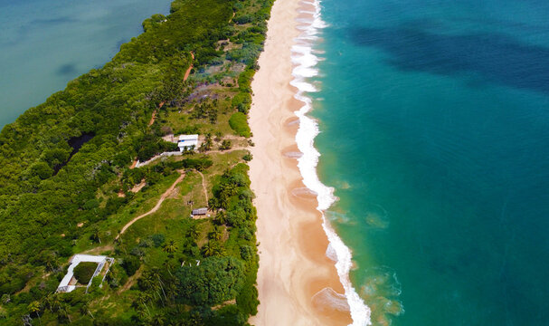 Aerial view of the long sandy tropical ocean shore. Beautiful tropical wallpapers for tourism and advertising. Asian landscape, drone photo