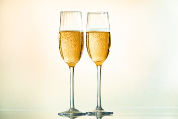 Minimalist image of two glasses of champagne with light tones