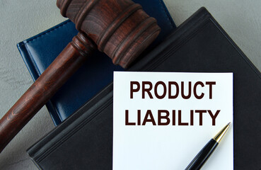 PRODUCT LIABILITY - words on a white sheet with leather notebooks, a judge's hammer and a pen