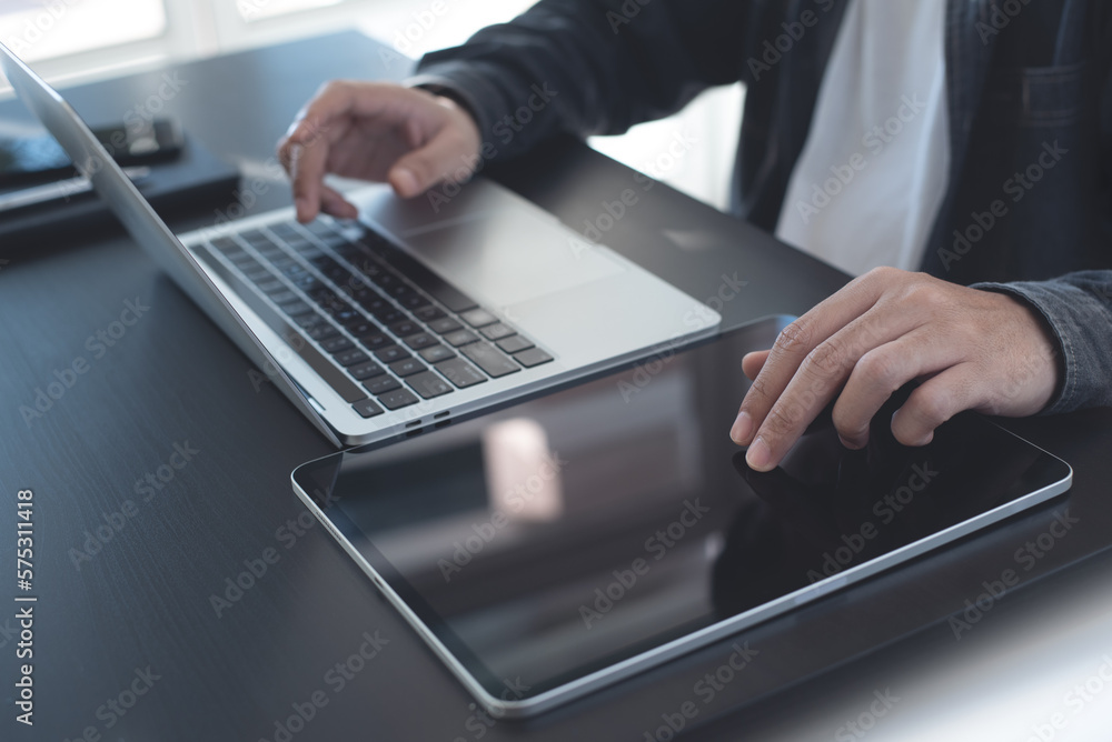 Aufkleber close up of man using digital tablet and working on laptop computer, browsing the internet, networki