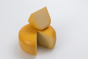 A piece of fresh processed cheese isolated on a white background