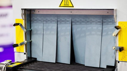 End Of The Conveyor Belt With Gray Screen. The Concept Of Industrial Technologies And Packaging Materials.