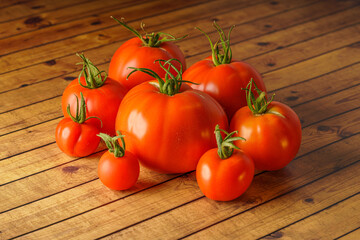 Red fresh tomatoes on wooden table background