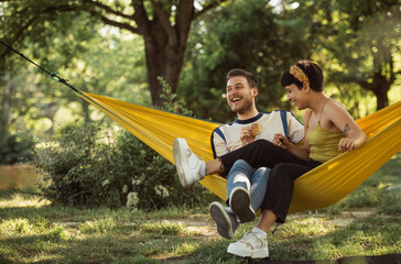 Couple on  hammock eating sandwiches