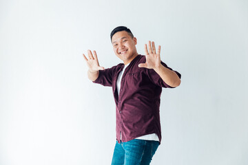 a man shows ten fingers on a white background