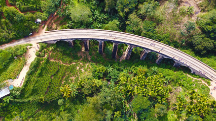 Aerial view of the old railway bridge in the tropical mountains. Beautiful tropical wallpapers for tourism and advertising. Asian landscape, drone photo