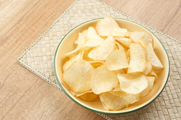 Keripik Singkong or Cassava Chips, Indonesian traditional snack. Served in bowl on wooden...