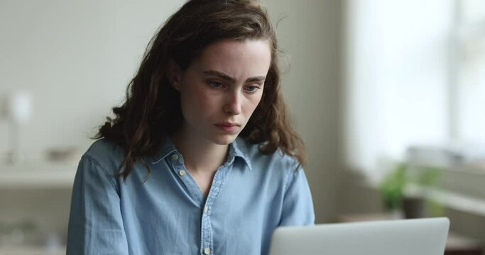 Girl cant concentrate, stacked in task, study, look at laptop screen make assignment, feels tired due to information overload, experiences troubles with hard work, touch temples suffers from overwork