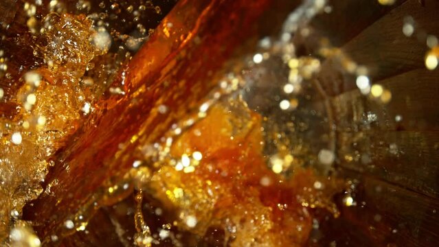 Super slow motion of pouring whiskey, rum or cognac inside the barrel. Filmed on high speed cinema camera, 1000fps. Ultimate composition view inside the wooden keg.