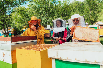 Arab investors checking the quality of honey on a large bee farm in which they have invested their money. The concept of investing in small businesses