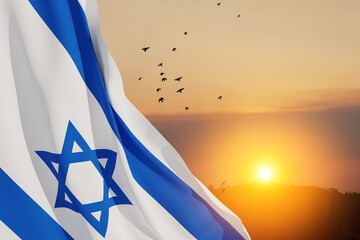Israel flag with a star of David over cloudy sky background with flying birds on sunset. Patriotic...