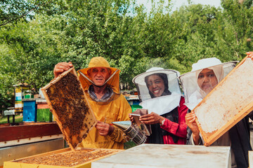 Arab investors checking the quality of honey on a large bee farm in which they have invested their money. The concept of investing in small businesses