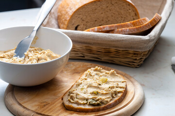 cracklings spread with pickled cucumber on slice of bread