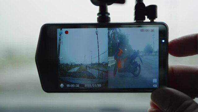 Smart driver checking video recorder in the car before driving, dash cam digital for safety road in traffic accident, Cam front windshield record traffic ahead and navigation.