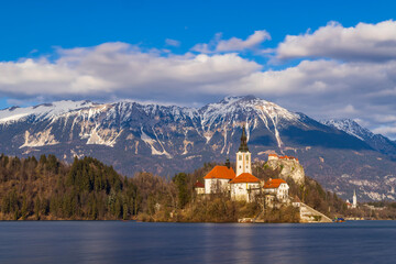 Bled lake with Bled catle, church and winter Julian Alps at background