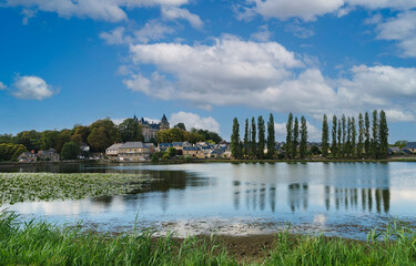View of the quiet lake quoted by Fran&ccedil;ois-Ren&eacute; de Chateaubriand in his memoirs d'ultratumba. In the background the French village of Combourg with blue sky and white clouds.